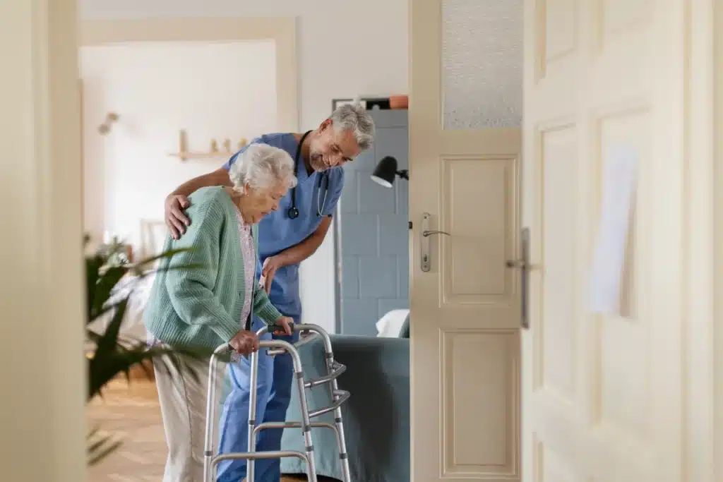 care worker assists resident at low income senior living home