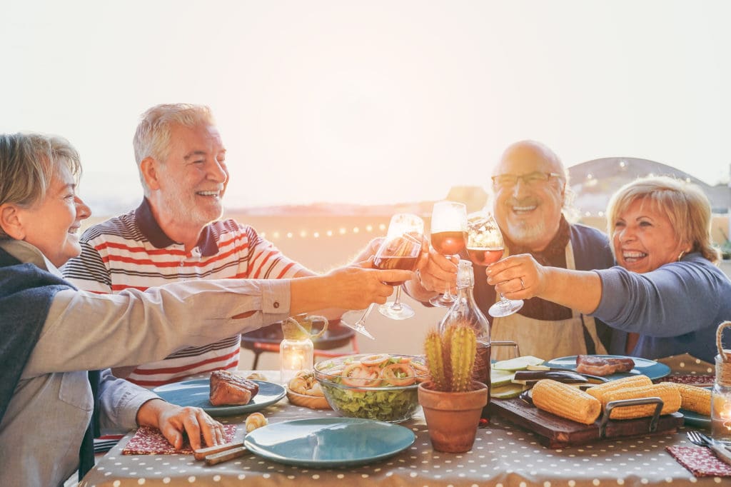 older couples enjoying sunset dinner at 55+ communities in Minnesota