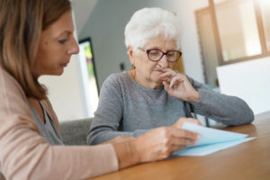 home assistant looking over CADI waiver with elderly woman