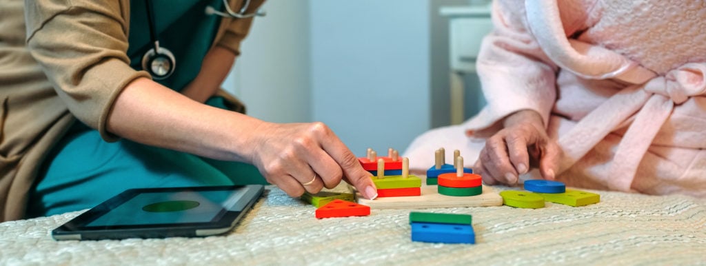 elderly person playing brian activity games for brain injury