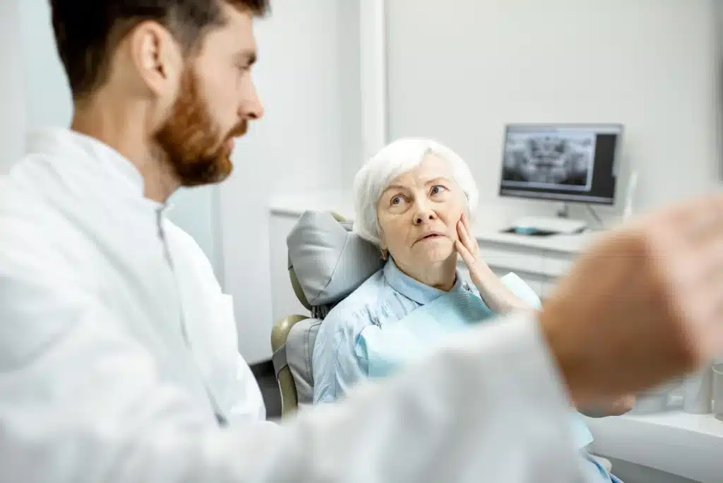 Elderly woman seeks dental attention for oral pains.