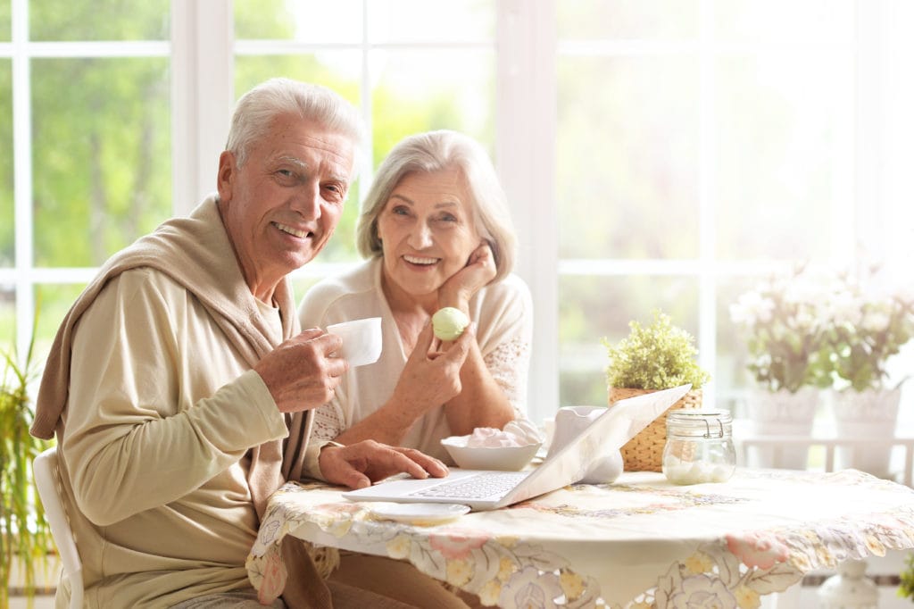 happy couple after their kids researched tips for moving parents into assisted living