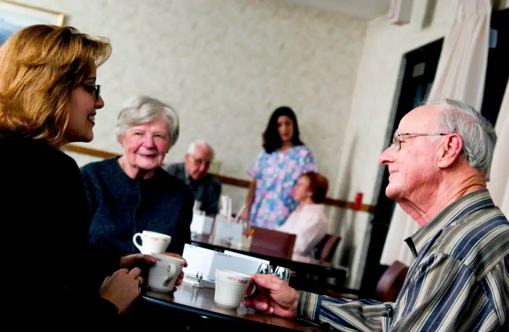 elderly folk in the early stages of dementia have breakfast