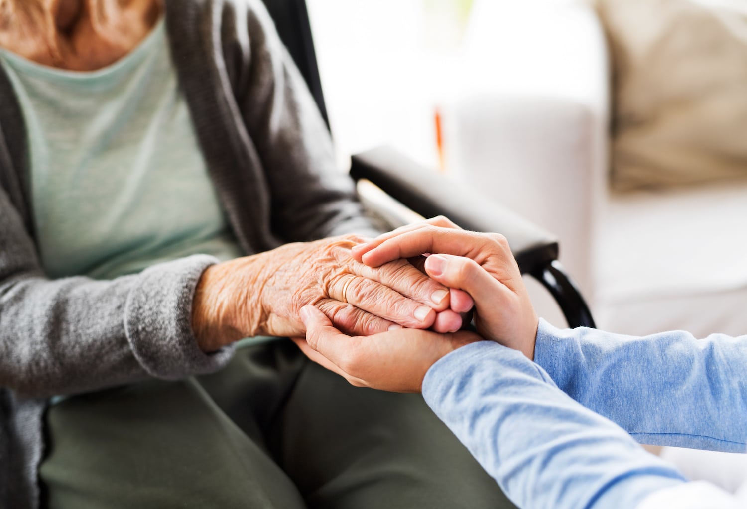 nursing home versus memory care holding hands