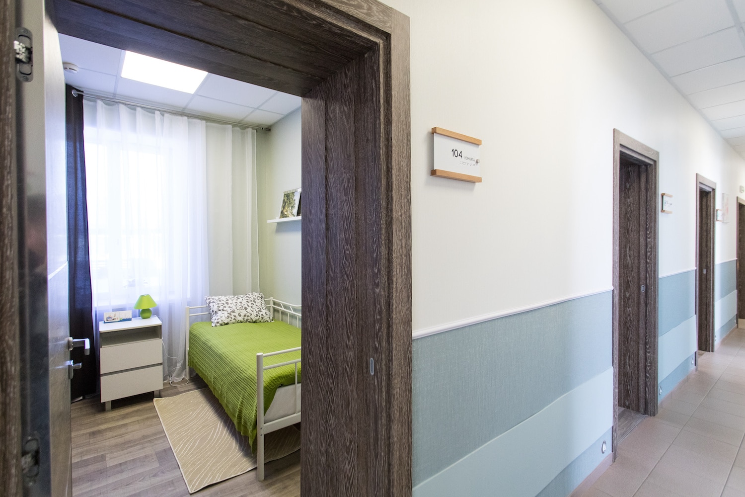 nursing home versus memory care room with green bed