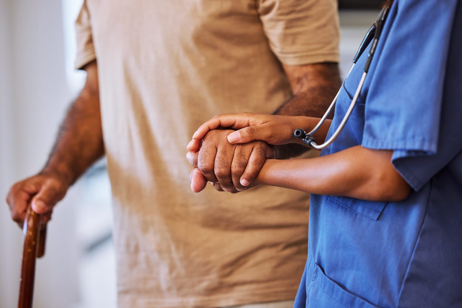 end stage dementia nurse holding patient hand