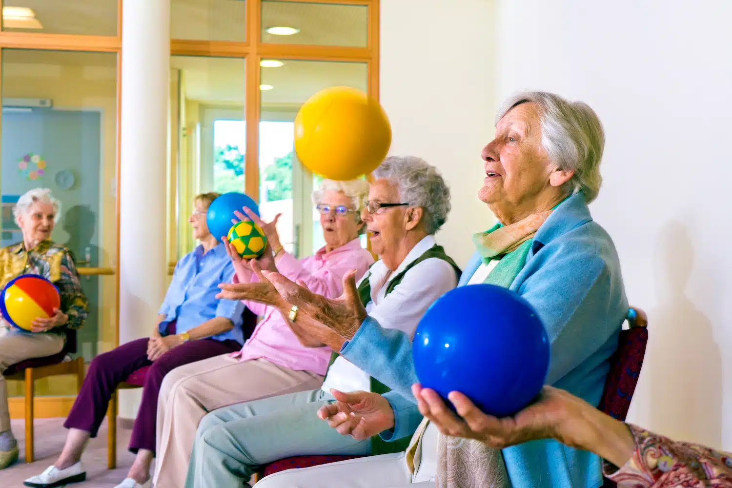 activities in assisted living community with colorful agility ball throws