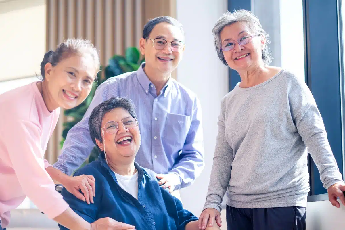 group of elder people laughing together in assisted living community