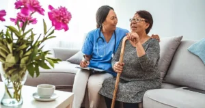 nurse examining the elderly woman at assisted living facility