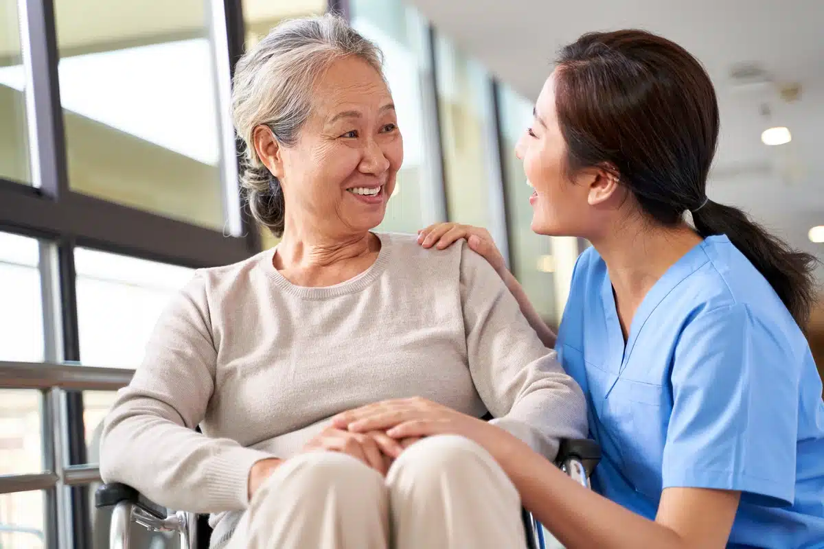 elderly woman and nurse talking at assisted living facility