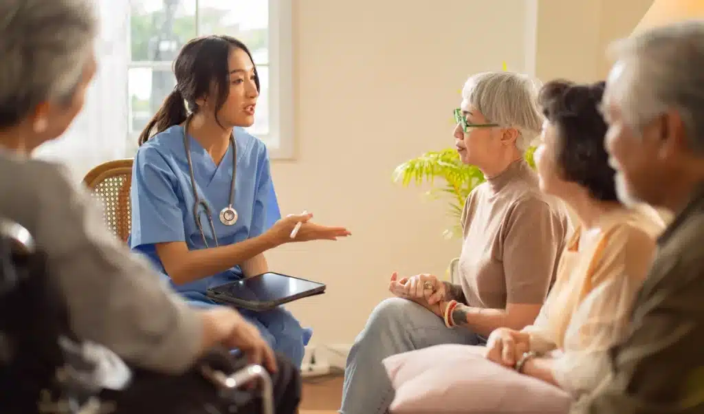 nurse talking to seniors at assisted living facility