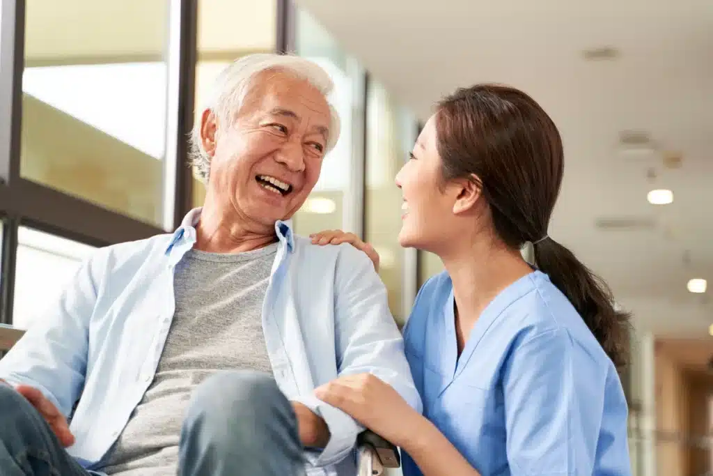 asian elderly man at nursing home talking to the nurse
