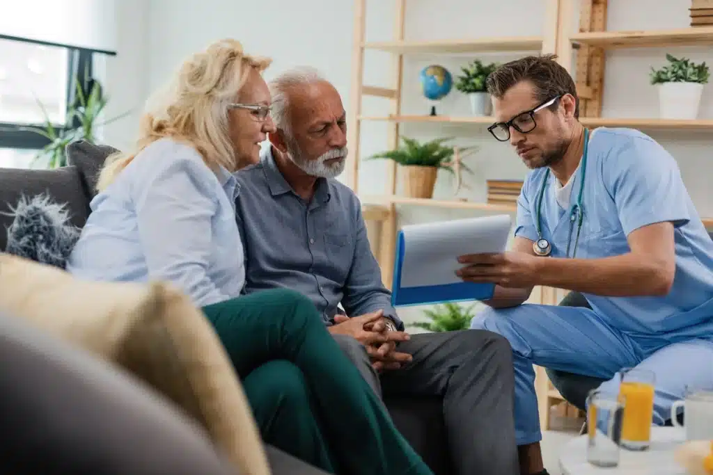 elderly couple learning their medical reports from healthcare worker 