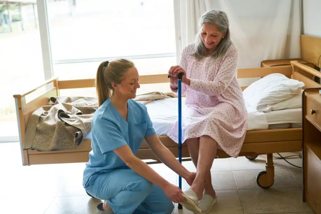 senior woman getting help wearing her shoes