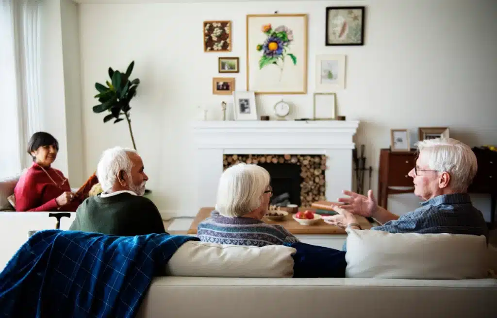 elderly people chatting on the couch