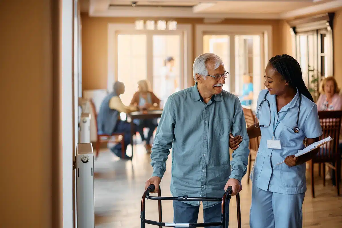 assisted living elderly man and nurse walking