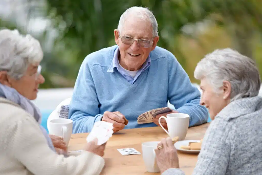 A group of senior citizens plays cards