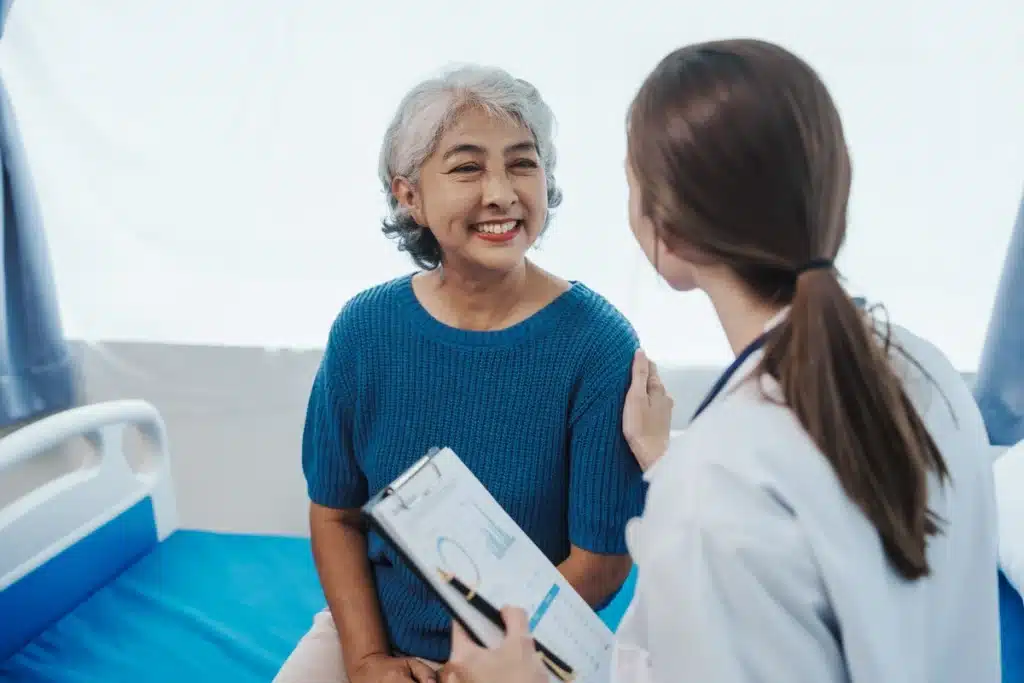 Elderly woman talks with her doctor