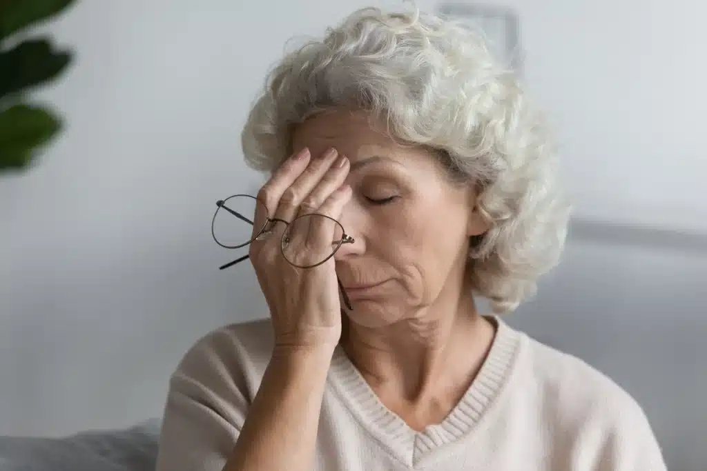 an older woman with a headache