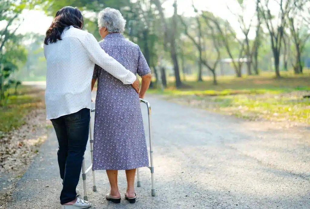 Elderly woman goes on afternoon walk with assisted living care worker