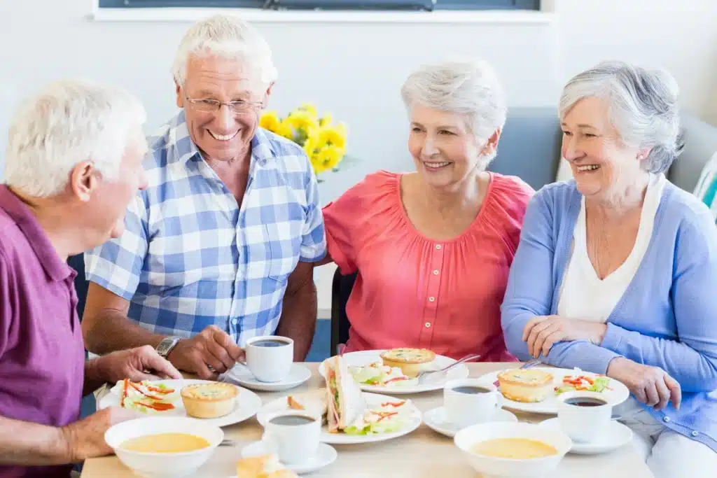 a group of senior citizens eating together