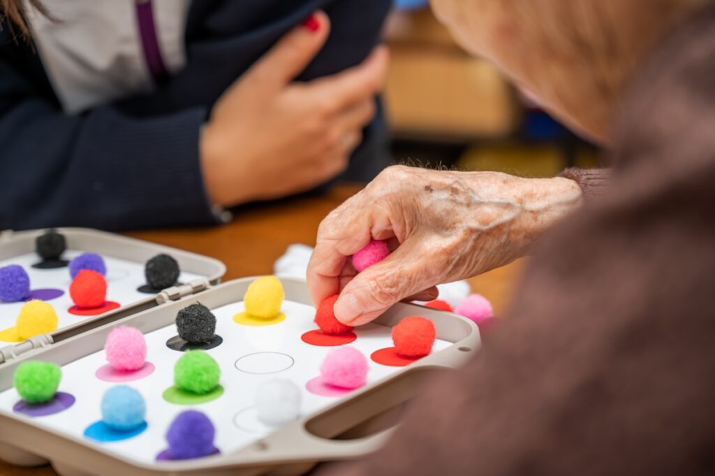 Rehabilitation center. Brain therapy cognitive psychological testing on senior patient. 