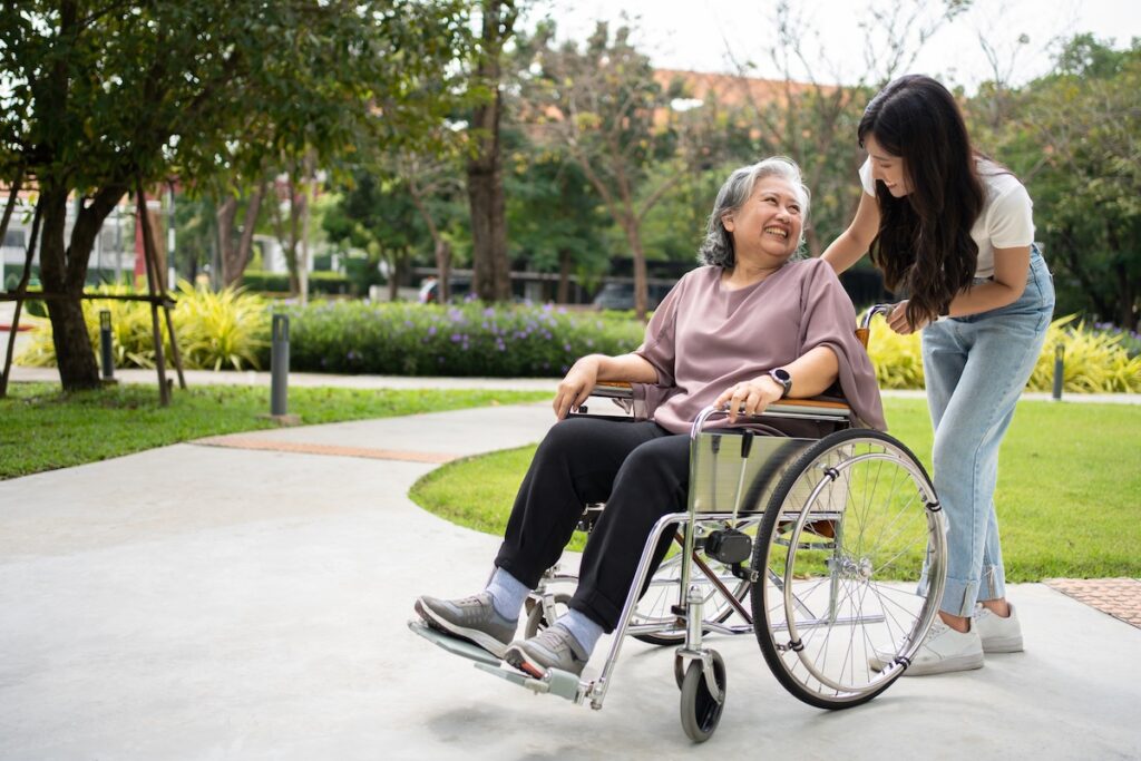 elderly mother and daughter smile at each other